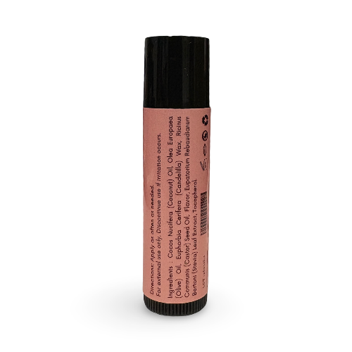 A single lip balm tube standing upright on a plain white background. The tube has a black cap and base, with a pink label showing product details and ingredients.